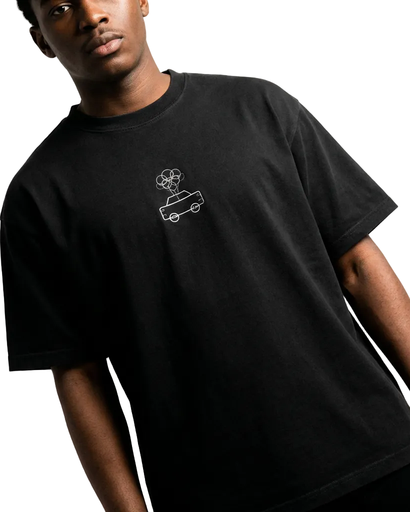 Person wearing a black t-shirt with a small graphic on a white background